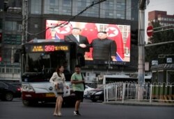 A television screen shows Chinese state media CCTV's footage of North Korean leader Kim Jong Un's meeting with Chinese President Xi Jinping in Pyongyang, at a street in Beijing, China, June 20, 2019
