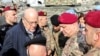 Lebanon's caretaker Prime Minister Najib Mikati (2nd-L) and Lebanese army commander, General Joseph Aoun (2nd-R), visit the southern Lebanese village of Khiam on Dec. 23, 2024, after the withdrawal of Israeli forces from the area. 