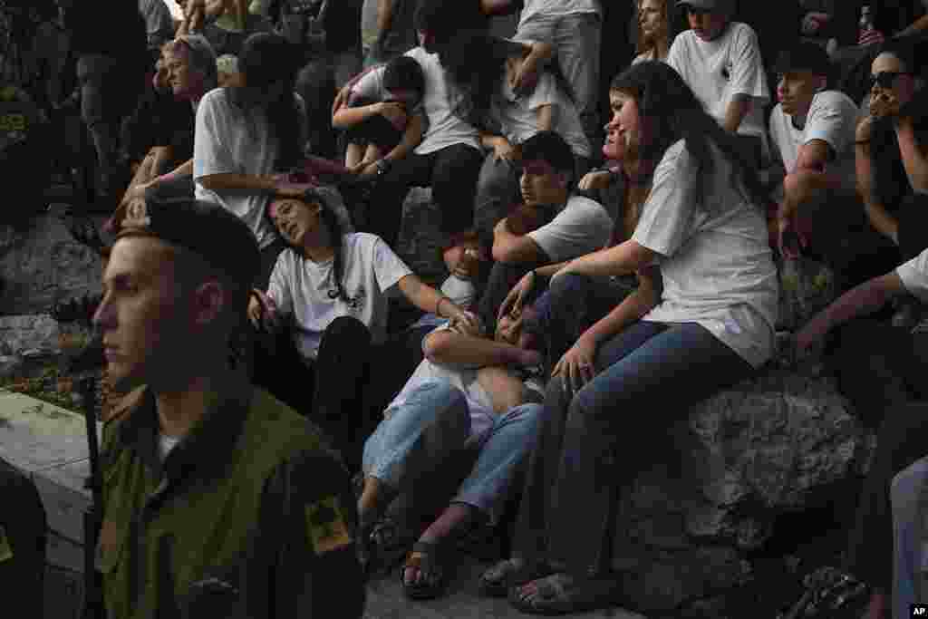 Mourners react during eulogies for Israeli soldier Capt. Itay Marcovich, who was killed in action in Lebanon, during his funeral in Kokhav Yair, Israel.