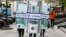 People dressed as blocks of currency notes walk along a street as part of a marketing campaign in Moscow, April 28, 2014.