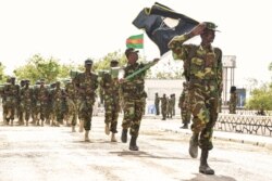 FILE - The Somalian army special commando unit known as Danab marches at army headquarters in Mogadishu, April 12, 2014.
