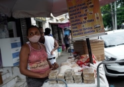 A street vendor wearing a mask amid COVID-19 sells cheese, beans, and sweets in Rio de Janeiro, Brazil, Oct. 9, 2020.