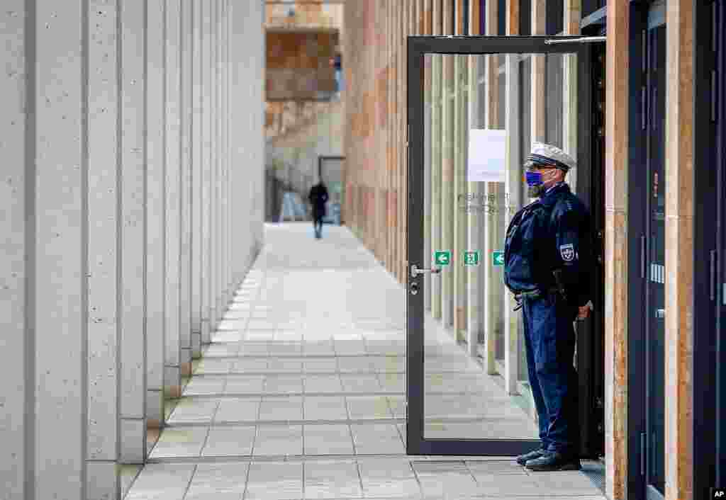 A police officer guards the entrance of a vaccine center that was introduced to the media in Wiesbaden, Germany.