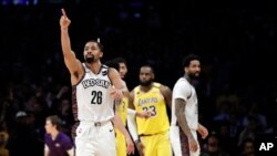 Brooklyn Nets' Spencer Dinwiddie (26) lobbies for a call to go in his team's favor during the second half of an NBA basketball game against the Los Angeles Lakers, March 10, 2020, in Los Angeles. 