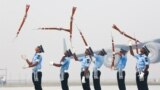 Indian Air Force soldiers toss their rifles during the full-dress rehearsal for Indian Air Force Day at the Hindon air force station on the outskirts of New Delhi.
