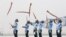 Indian Air Force soldiers toss their rifles during the full-dress rehearsal for Indian Air Force Day at the Hindon air force station on the outskirts of New Delhi.