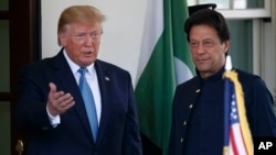 President Donald Trump gestures as he greets Pakistan's Prime Minister Imran Khan as he arrives at the White House, Monday, July 22, 2019, in Washington.