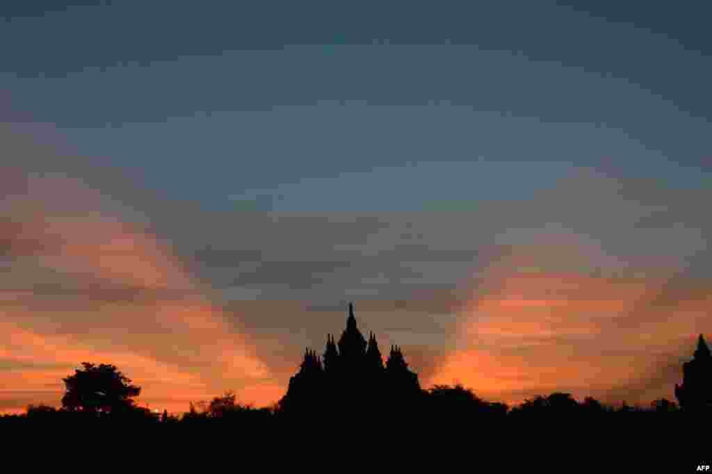 Sun rays beam at dawn over the Plaosan Buddhist temple located in the Klaten regency in Indonesia&#39;s central Java province. 