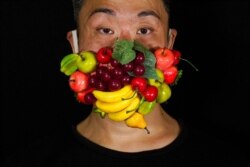 Edmond Kok, a Hong Kong theater costume designer and actor, wears a face mask designed to look like fruits in Hong Kong Aug. 6, 2020.