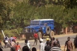 FILE - Protesters pelt police vehicles with stones in Lilongwe in this undated photo. Angry prison guards in Malawi attacked armory vehicles when police tried to stop their strike, April 24, 2020. (Lameck Masina/VOA)