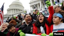 Protesters urge Congress to pass a bill that will allow undocumented immigrants who were brought to America as children to permanently stay in the country, on the Senate steps in Washington, Dec. 6, 2017.