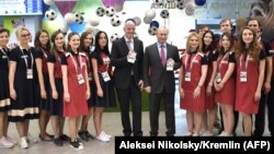 RUSSIA -- Russian President Vladimir Putin and FIFA president Gianni Infantino pose with their FAN IDs for the 2018 FIFA World Cup Russia at a distribution centre in Sochi, May 3, 2018