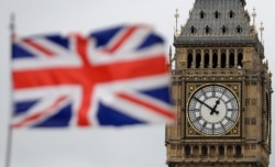 FILE - British Union flag waves in front of the Elizabeth Tower at Houses of Parliament containing the bell know as "Big Ben" in central London, March 29, 2017.