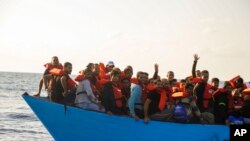 FILE - Migrants are rescued from the sea some 30 miles off Libya by the members of the humanitarian ship Geo Barents, October 6, 2023.