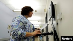 Geisinger Health System maternity ward nurse Nichole Madara enters and checks patient medical records in Geisinger's computerized health records system on the Geisinger Health Campus in Danville, Pennsylvania, Oct. 29, 2009. 