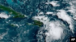 This satellite image provided by the National Oceanic and Atmospheric Administration (NOAA) shows Tropical Storm Fred in the Caribbean as it passes south of Puerto Rico and the Dominican Republic, Aug. 11, 2021.