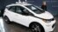 FILE - General Motors Chairman and Chief Executive Officer Mary Barra stands next to an autonomous Chevrolet Bolt electric car, Dec. 15, 2016, in Detroit.