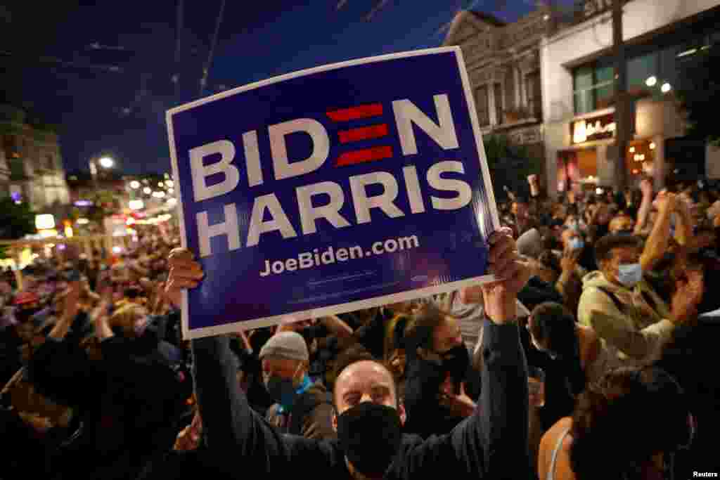 A demonstrator reacts while listening to U.S. presidential nominee Joe Biden and vice presidential nominee Kamala Harris speak in the Castro district of San Francisco, CA, Nov. 7, 2020.