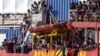 Migrants rescued in the Mediterranean sea arrive to disembark from the Sea-Eye 4 ship, Nov. 7, 2021, in the port of Trapani, Sicily, Italy. 