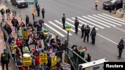 Демонстранты у здания Колумбийского университета в знак солидарности с про-палестинскими организаторами сидячей забастовки в кампусе Колумбийского университета в Нью-Йорке, США, 19 апреля 2024 года.