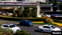 FILE - BYD's electric vehicle Yuan Plus moves on a street in Beijing October 20, 2023.