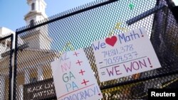 Posters displaying election results hang on the fence outside of St. John&#39;s Church near the White House in Washington, D.C., after a presidential election victory was called for former Vice President Joe Biden.