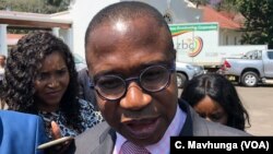 FILE: Mthuli Ncube, Zimbabwe’s new finance minister, talking to reporters after taking oath of office in Harare, Sept. 10, 2018. 