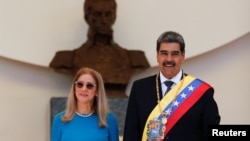 Venezuelan President Nicolas Maduro and his wife, Cilia Flores, react at his inauguration for a third six-year term, in Caracas on Jan. 10, 2025. On the day of his inauguration, the U.S. increased to $25 million the reward it is offering for Maduro's arrest.