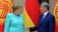 German Chancellor Angela Merkel and Kyrgyz President Almazbek Atambayev talk during their meeting in Bishkek, Kyrgyzstan, July 14, 2016.