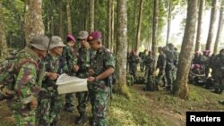 ທະຫານມາຣີນອິນໂດເນເຊຍ ພວມສຶກສາເບິ່ງແຜນທີ່ ບ່ອນທີ່ເຮືອບິນຕົກ ໃນເຂດປ່າສະຫງວນ Halimun ໃກ້ໆເມືອງ Bogor (10 ພຶດສະພາ 2012)