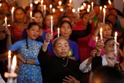 FILE - Catholics attend a mass prayer for 39 people found dead in the back of a truck near London, at My Khanh parish in Nghe An province, Vietnam, Oct. 26, 2019. The last of the 39 migrants returned home Saturday.
