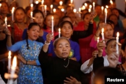 FILE - Catholics attend a mass prayer for 39 people found dead in the back of a truck near London, at My Khanh parish in Nghe An province, Vietnam, Oct. 26, 2019. The last of the 39 migrants returned home Saturday.