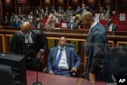 FILE—Former South African President Jacob Zuma, centre, with his legal team in the High Court in Pietermaritzburg, South Africa on January 31, 2022 during a hearing of his corruption trial.