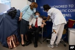 Yehuda Widawsky, a 102-year-old Holocaust survivor, receives a third Pfizer-BioNTech COVID-19 vaccine at a hospital in Tel Aviv, Israel, Aug. 1, 2021.