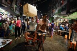 People attend a night protest against the military coup in Yangon, Myanmar, Feb. 5, 2021.