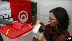 A Tunisian woman residing in Morocco casts her vote at the polling station inside the Tunisian Embassy in Rabat, October 21, 2011. Tunisians will vote in an election on October 23 that will shape the country's future direction after a revolution earlier t