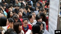 FILE - Candidates arrive for China's national civil service exam at a university in Nanjing, Jiangsu province, Nov. 24, 2013. Competition for civil service positions has intensified in 2024.