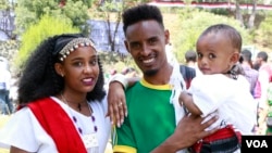 Tedi Shifera Tola from North Shewa Zone of Oromia poses for a photograph  with his household  arsenic  they observe  Ireecha successful  Addis Ababa, Ethiopia.