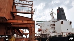 A cargo ship is loaded with bauxite at the bauxite factory of Guinea's largest mining firm, Compagnie des Bauxites de Guinee (CBG), at Kamsar, a town north of the capital Conakry (2008 file photo)