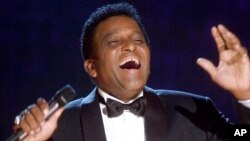 FILE - Charley Pride performs during his induction into the Country Music Hall of Fame at the Country Music Association Awards show at the Grand Ole Opry House in Nashville, Tenn., Oct. 4, 2000.