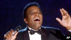 FILE - Charley Pride performs during his induction into the Country Music Hall of Fame at the Country Music Association Awards show at the Grand Ole Opry House in Nashville, Tenn., Oct. 4, 2000.