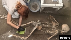 An archaeologist works on the recently discovered remains of a victim in the archaeological site of the ancient city of Pompeii, which was destroyed in AD 79 by the eruption of Mount Vesuvius, in Pompeii Italy, July 5, 2024. Parco Acheologico di Pompei/Handout via REUTERS 