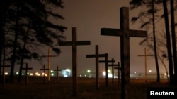 Crosses are seen during a "Night of the executed poets" event at a mass grave in Kuropaty on the outskirts of Minsk, Oct. 29, 2018.