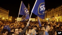 Opposition supporters reacts on the street in Tbilisi Georgia, Monday, Oct. 1, 2012.