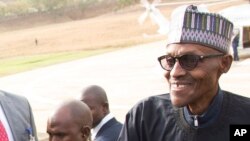 FILE - Nigeria President Muhammadu Buhari (right) is welcomed by Nigeria Vice President Yemi Osinbajo (left) upon arrival from his medical vacation in Abuja, Nigeria, March 10, 2017.