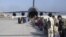 In this image provided by the U.S. Air Force, U.S. Air Force loadmasters and pilots assigned to the 816th Expeditionary Airlift Squadron, load people being evacuated from Afghanistan onto a U.S. Air Force C-17 Globemaster III at Hamid Karzai International