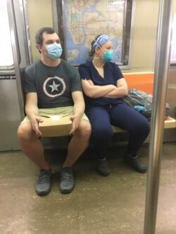 FILE - Subway riders seen during the Coronavirus Pandemic in New York City, May 29, 2020.