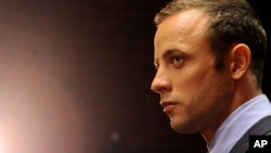 In this Feb. 22, 2013 file photo, Olympic athlete Oscar Pistorius stands in the dock during his bail hearing in Pretoria, South Africa. 