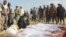 FILE - Afghan villagers gather around several victims of clashes between Taliban and Afghan security forces in the Taliban-controlled, Buz-e Kandahari village in Kunduz province, Afghanistan, Nov. 4, 2016. 