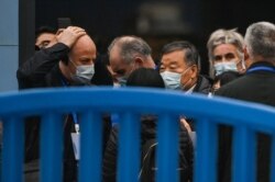 FILE - Members of the World Health Organization (WHO) team, investigating the origins of the Covid-19 coronavirus, visit the closed Huanan Seafood wholesale market in Wuhan, China's central Hubei province, Jan. 31, 2021.